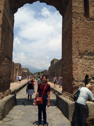 An archway between two neighborhoods. Homes are visible lining the streets